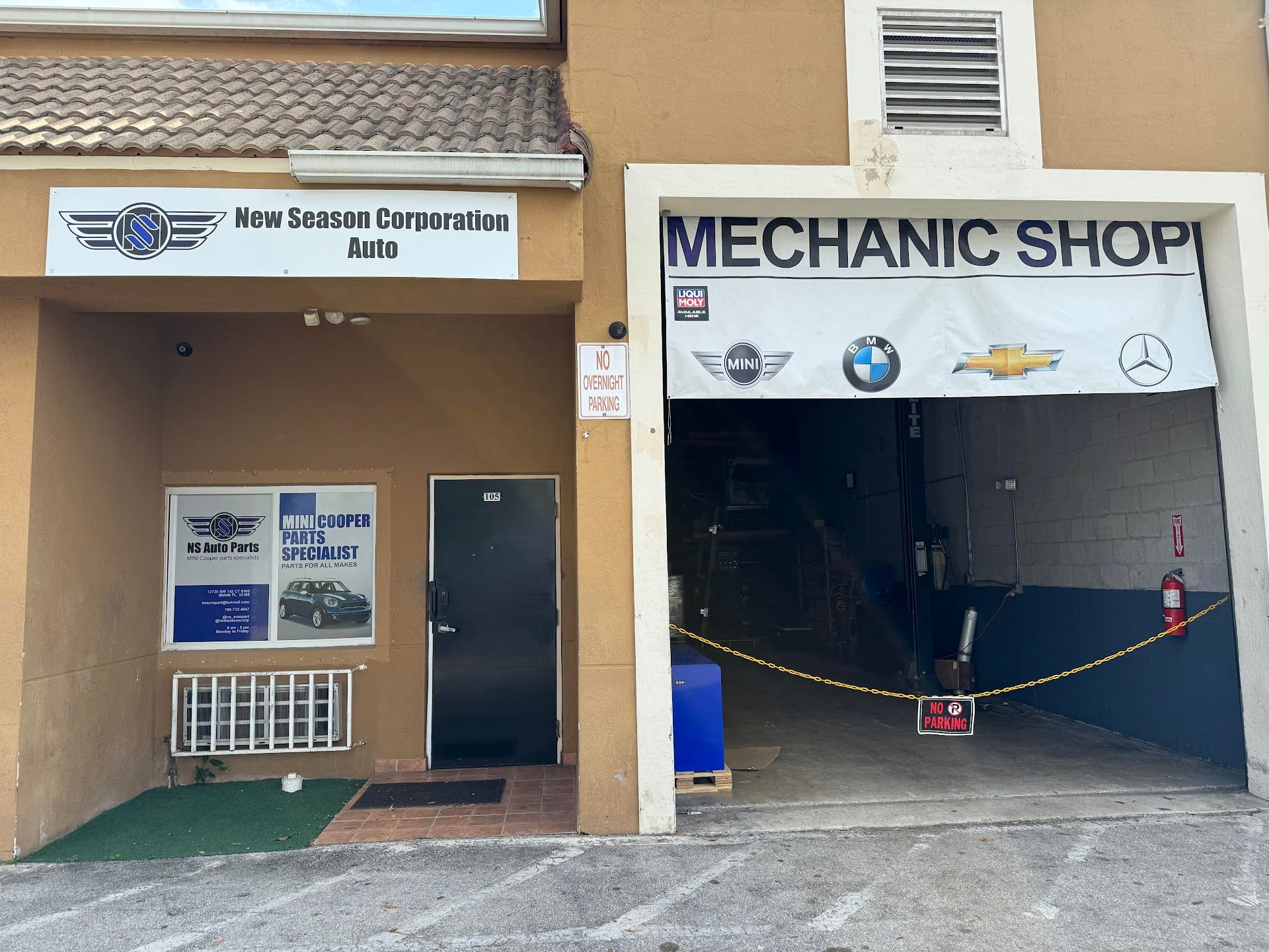 New Season Corporation storefront: the sign over unit 105, the NS Auto Parts window and the open mechanic bay with a two-post lift